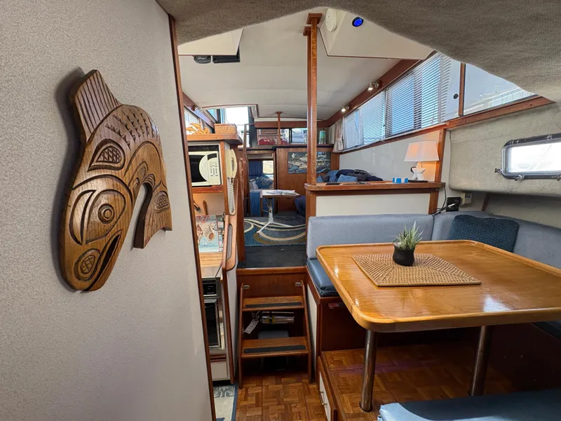Slide: The Image of Interior of 1988 Carver 36 Aft Cabin with wooden decor and dining area. - 38