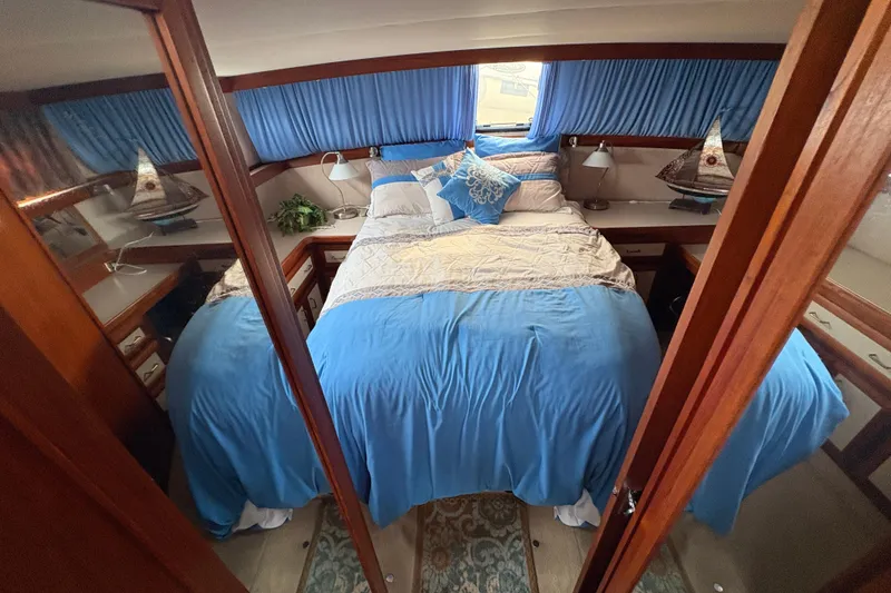 Slide: The Image of Interior of 1988 Carver 36 Aft Cabin with cozy bed and nautical decor. - 46