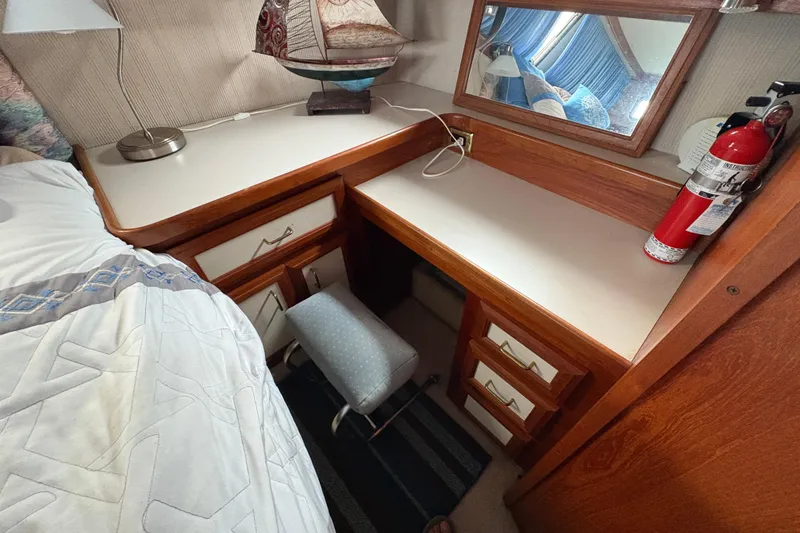 Slide: The Image of 1988 Carver 36 Aft Cabin interior with desk, mirror, and fire extinguisher. - 50
