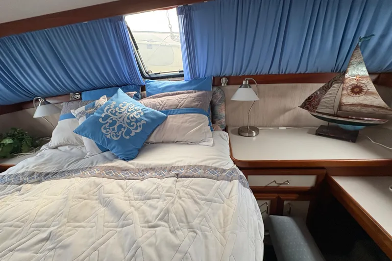 Slide: The Image of Cozy bedroom in 1988 Carver 36 Aft Cabin with nautical decor and blue accents. - 51