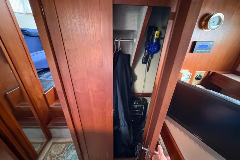 Slide: The Image of 1988 Carver 36 Aft Cabin interior closet with wooden finish and electronic controls. - 58
