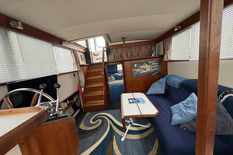 Slide: The Image of Interior of 1988 Carver 36 Aft Cabin with cozy seating and nautical decor. - 64