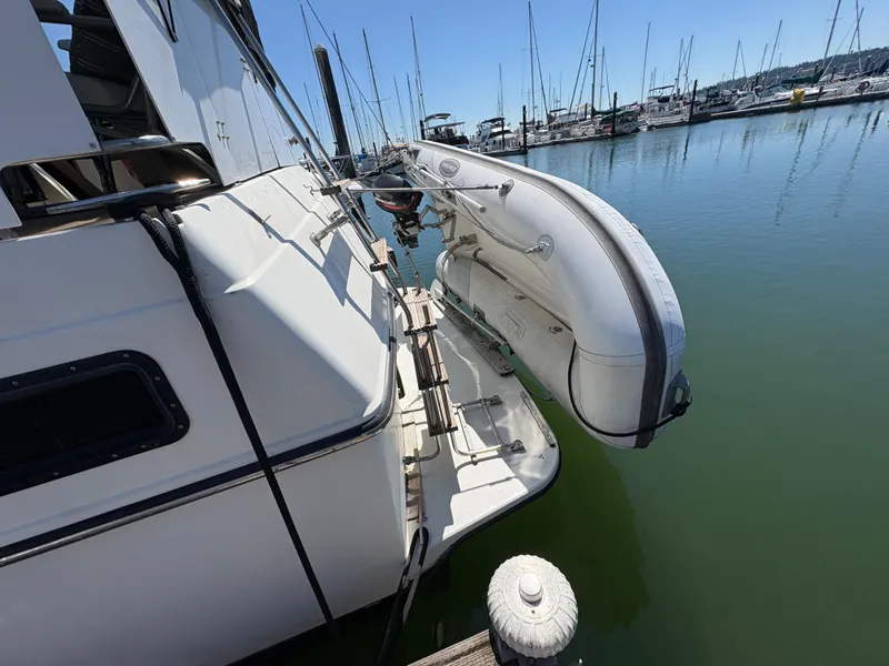 Slide: The Image of 1988 Carver 36 Aft Cabin yacht with dinghy, docked in a marina. - 7