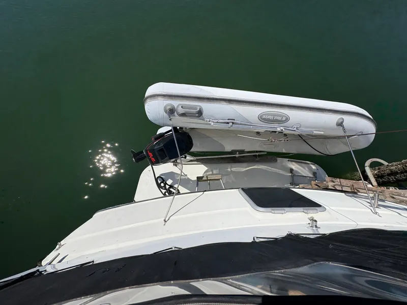 Slide: The Image of 1988 Carver 36 Aft Cabin with dinghy on calm water, top view. - 9