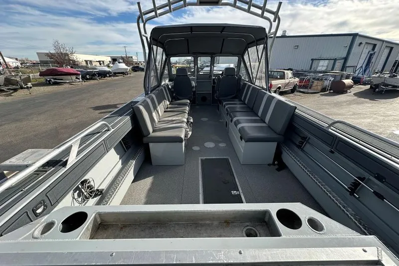 Slide: The Image of 2021 Hewescraft 240 Ocean Pro boat interior with seating and storage, parked outdoors. - 3