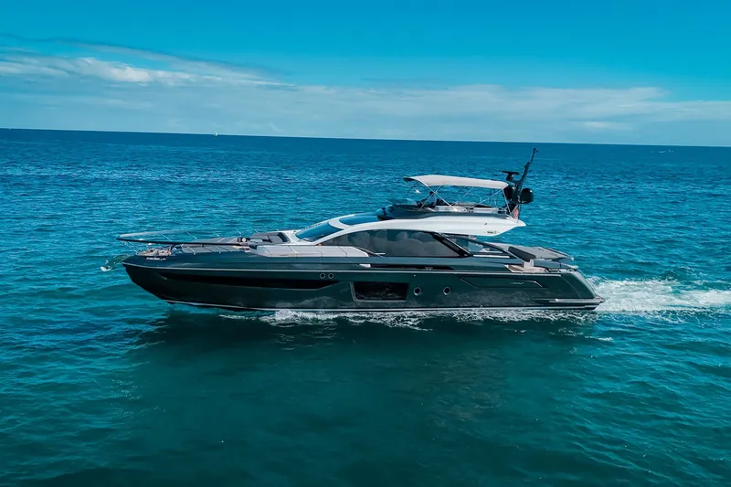 The Image of 2023 Azimut S8 yacht cruising on open blue sea under clear sky. - 0