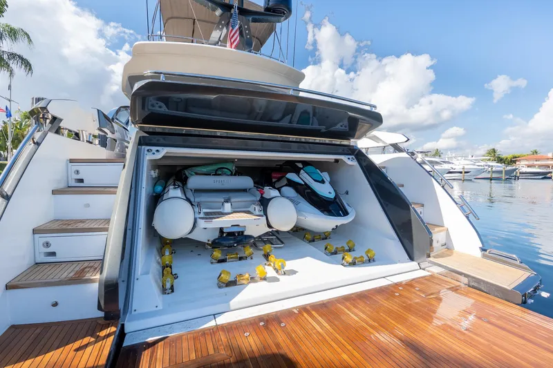 Slide: The Image of 2023 Azimut S8 yacht with open garage, showcasing watercraft and equipment. - 13