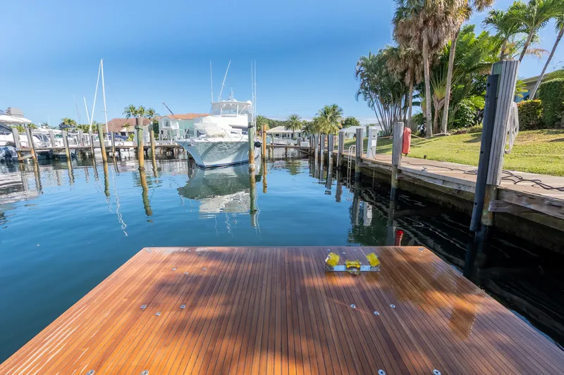 Slide: The Image of Dock view with Azimut S8 yacht, 2023 model, in a serene marina setting. - 14