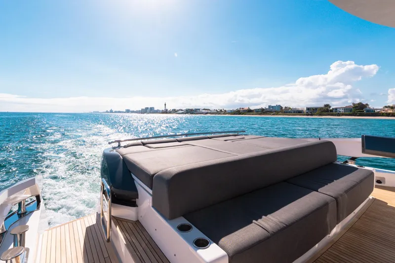 Slide: The Image of 2023 Azimut S8 yacht cruising on sunny ocean with luxurious deck seating. - 19