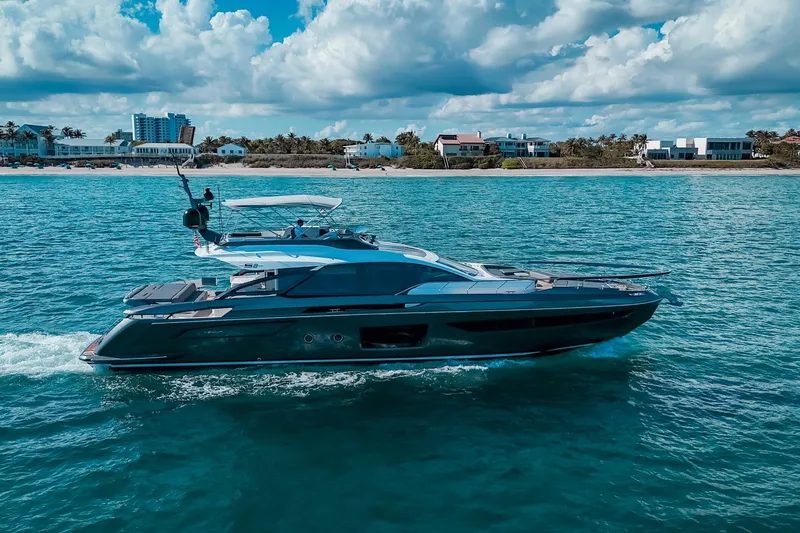 Slide: The Image of 2023 Azimut S8 yacht cruising on clear blue waters under a partly cloudy sky. - 29