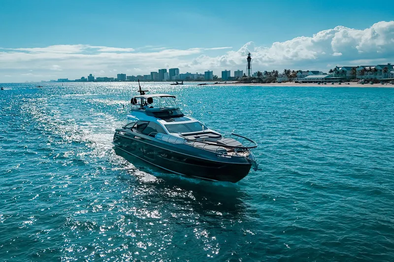 Slide: The Image of 2023 Azimut S8 yacht cruising on a sunny ocean near a coastal cityscape. - 3