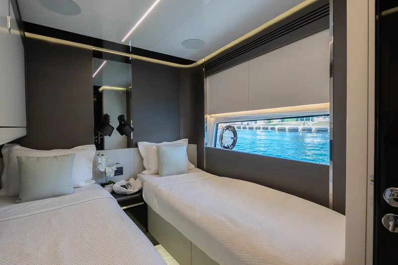 Slide: The Image of Luxurious 2023 Azimut S8 yacht cabin with twin beds and ocean view window. - 47
