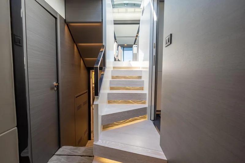 Slide: The Image of Interior staircase of 2023 Azimut S8 yacht, featuring modern design and ambient lighting. - 56