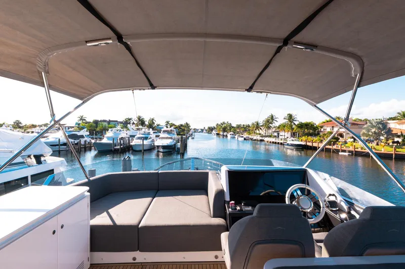Slide: The Image of 2023 Azimut S8 yacht interior with waterfront view, featuring luxurious seating and modern controls. - 71