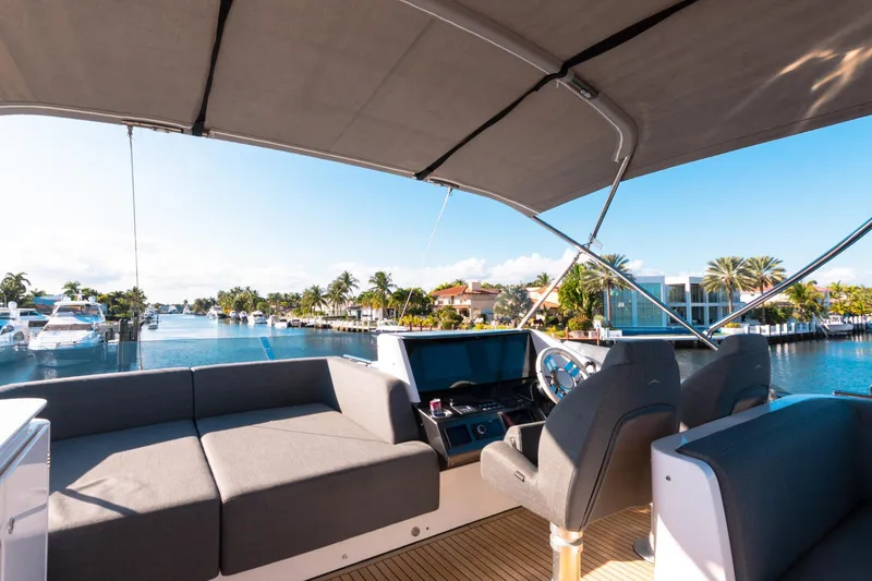 Slide: The Image of 2023 Azimut S8 yacht interior with waterfront view, featuring luxurious seating and modern helm. - 76
