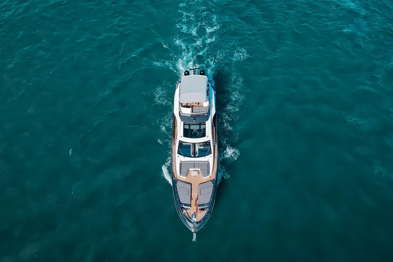 Slide: The Image of Aerial view of 2023 Azimut S8 yacht cruising on open blue water. - 82