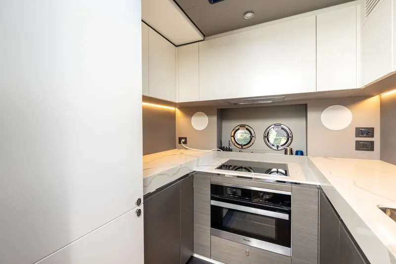 Slide: The Image of Modern kitchen in 2023 Azimut S8 yacht with sleek design and porthole windows. - 87