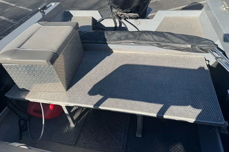 Slide: The Image of 2018 KingFisher 1825 Falcon boat interior with cushioned seat and carpeted deck. - 11