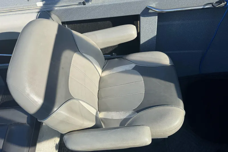 Slide: The Image of Gray seat in 2018 KingFisher 1825 Falcon boat, featuring armrests and sleek design. - 13