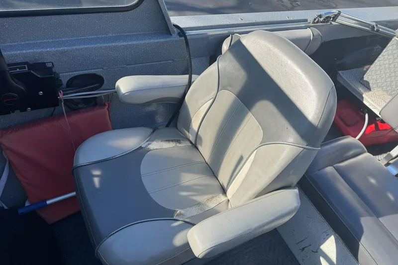 Slide: The Image of Captain's seat in a 2018 KingFisher 1825 Falcon boat, featuring gray upholstery. - 14