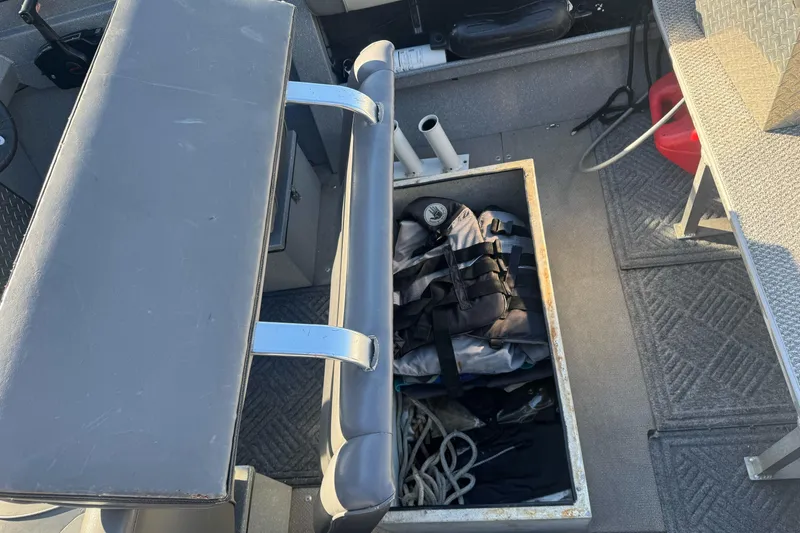Slide: The Image of Interior of 2018 KingFisher 1825 Falcon boat showing storage compartment with life jackets and ropes. - 17