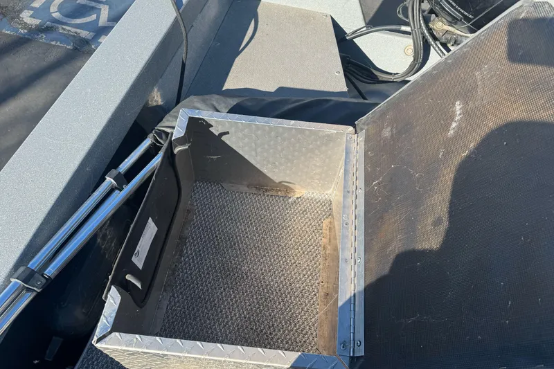 Slide: The Image of Open storage compartment on 2018 KingFisher 1825 Falcon boat, showing interior details. - 18