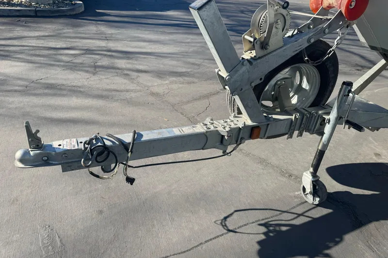 Slide: The Image of Trailer hitch of a 2018 KingFisher 1825 Falcon boat on pavement. - 6