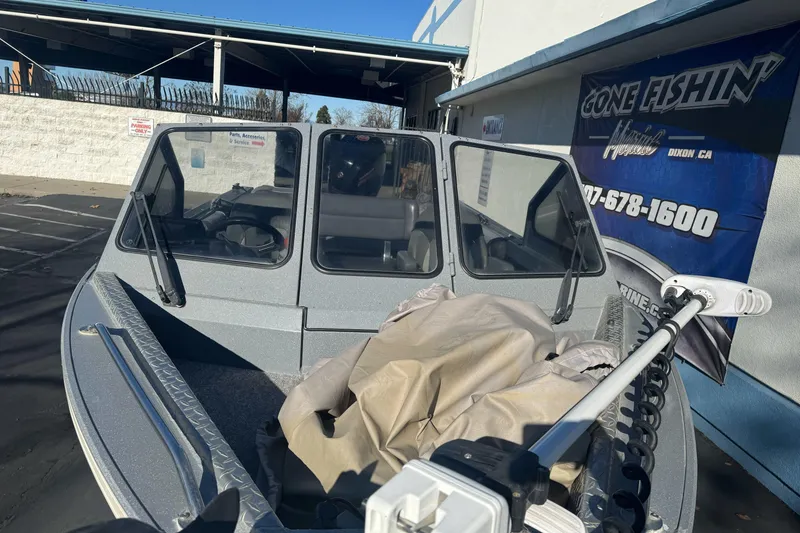 Slide: The Image of 2018 KingFisher 1825 Falcon boat parked near a "Gone Fishin'" banner. - 8