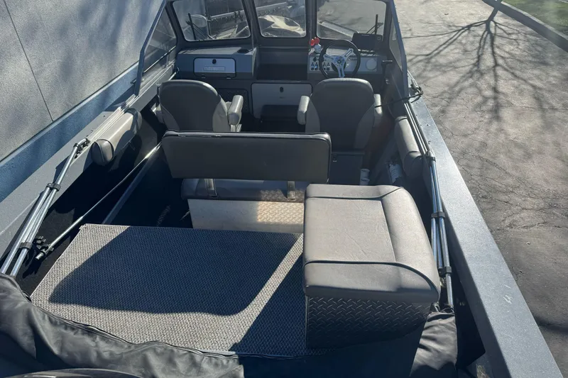 Slide: The Image of 2018 KingFisher 1825 Falcon boat interior with seating and steering wheel. - 9