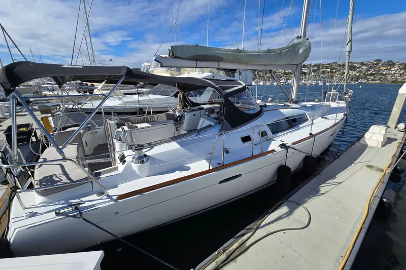 Slide: The Image of 2008 Beneteau Oceanis 49 sailboat docked at marina under clear blue sky. - 1