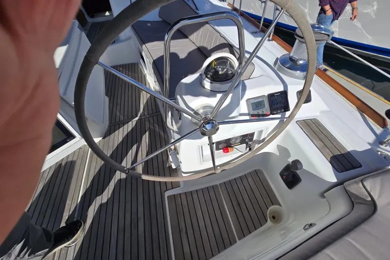 Slide: The Image of Steering wheel and controls of a 2008 Beneteau Oceanis 49 sailboat cockpit. - 10