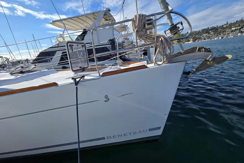 Slide: The Image of 2008 Beneteau Oceanis 49 sailboat docked in a marina, featuring sleek design and clear skies. - 12