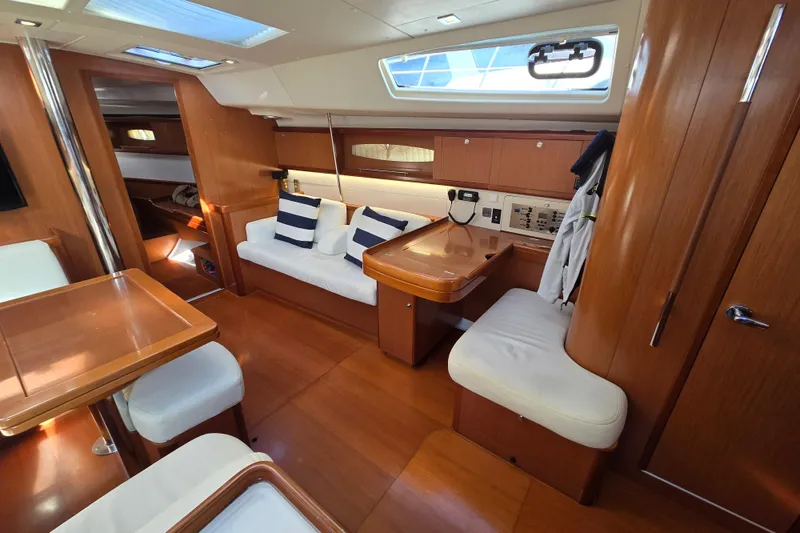 Slide: The Image of Luxurious interior of 2008 Beneteau Oceanis 49 yacht with wood finish and seating area. - 23