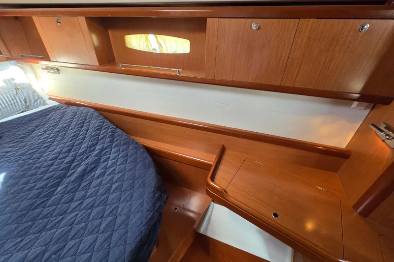Slide: The Image of Interior cabin of 2008 Beneteau Oceanis 49 yacht with wooden cabinetry and bed. - 27