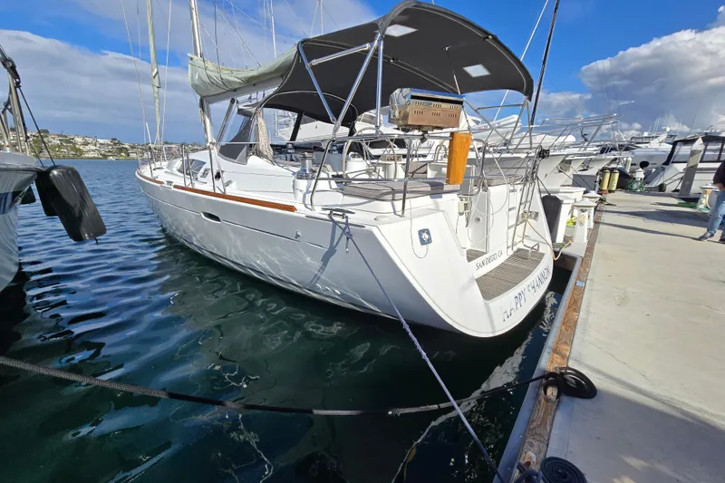 Slide: The Image of 2008 Beneteau Oceanis 49 sailboat docked in marina, sunny day, calm waters. - 3