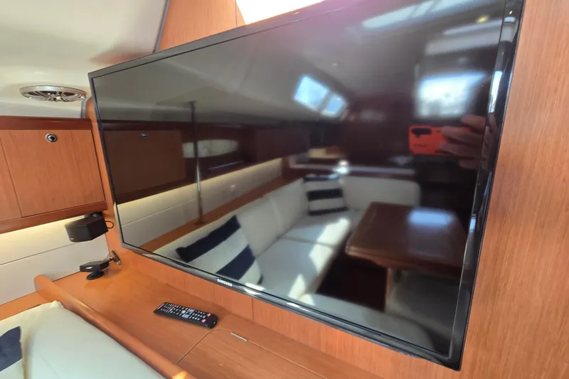 Slide: The Image of Interior of 2008 Beneteau Oceanis 49 yacht with TV and cozy seating area. - 33
