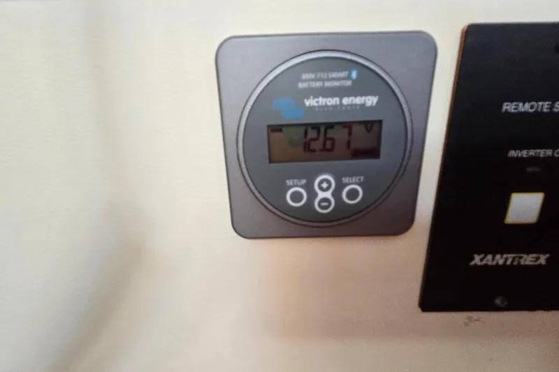 Slide: The Image of Victron Energy battery monitor displaying 12.67V on a 2008 Beneteau Oceanis 49 yacht. - 38