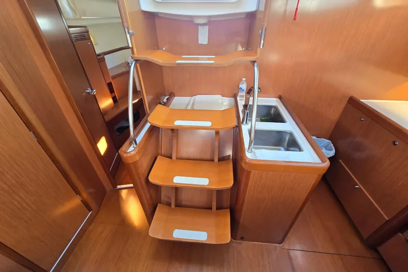 Slide: The Image of Interior of 2008 Beneteau Oceanis 49 yacht, featuring wooden stairs and dual sinks. - 41
