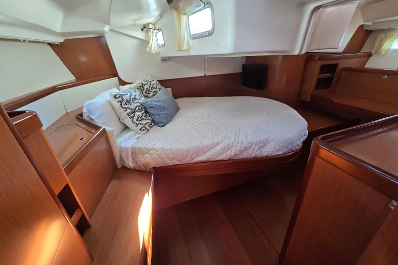 Slide: The Image of Luxurious cabin interior of 2008 Beneteau Oceanis 49 yacht with cozy bed and wooden finish. - 42