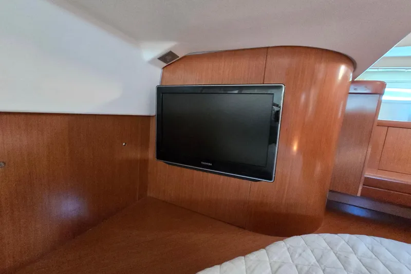 Slide: The Image of Interior of 2008 Beneteau Oceanis 49 yacht with mounted TV on wooden paneling. - 44