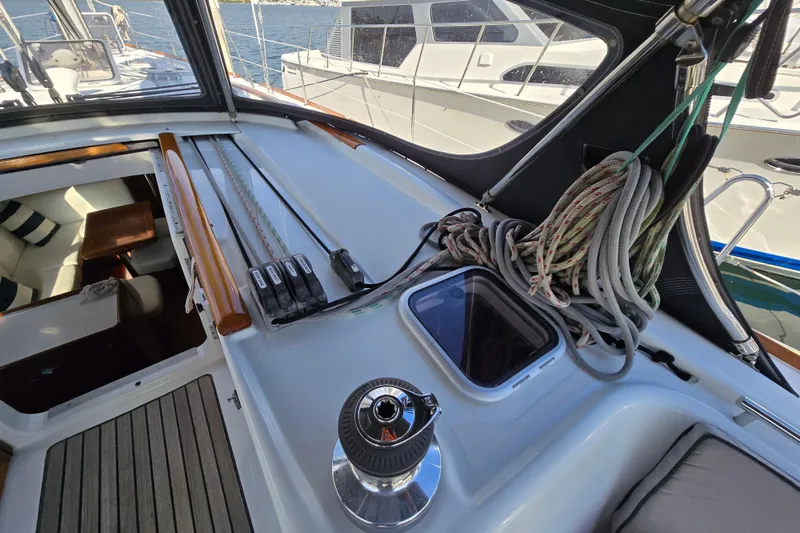 Slide: The Image of 2008 Beneteau Oceanis 49 yacht deck with winch, ropes, and cockpit view. - 6