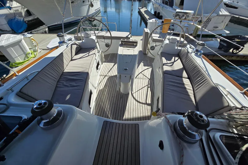 Slide: The Image of 2008 Beneteau Oceanis 49 yacht cockpit with cushioned seating and steering wheels. - 7