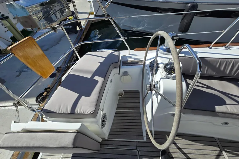 Slide: The Image of Cockpit of 2008 Beneteau Oceanis 49 sailboat with steering wheel and cushioned seating. - 8