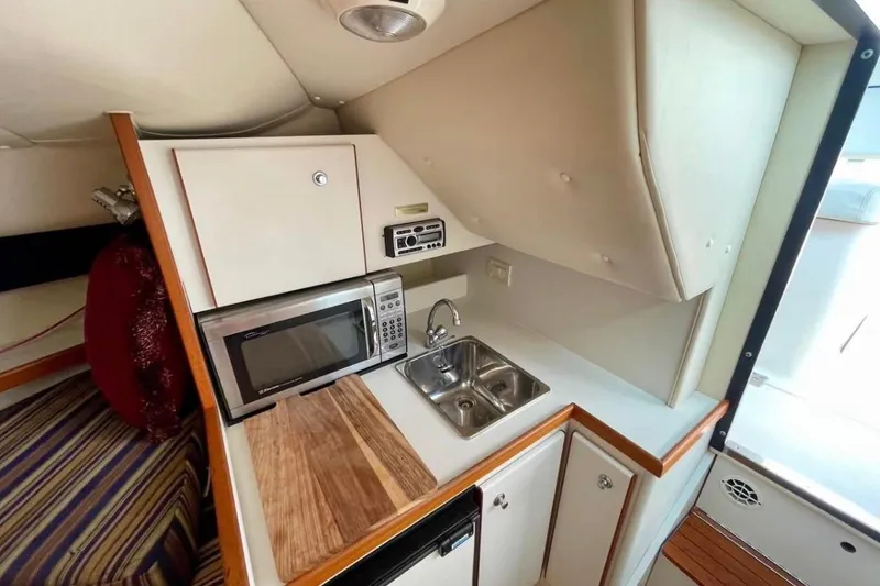 Slide: The Image of 2003 Tiara Yachts 2900 Coronet interior kitchen with microwave and sink. - 6