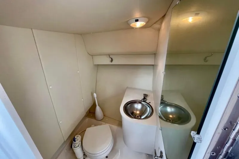 Slide: The Image of Compact bathroom in 2003 Tiara Yachts 2900 Coronet with toilet and stainless steel sink. - 7