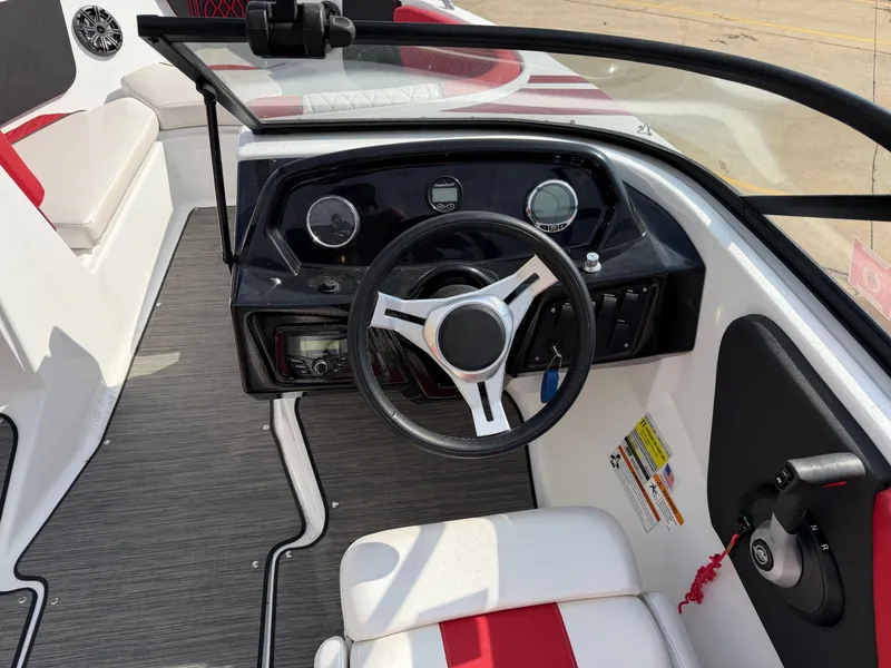 Slide: The Image of 2022 Glastron 210 GX boat cockpit with steering wheel. - 12