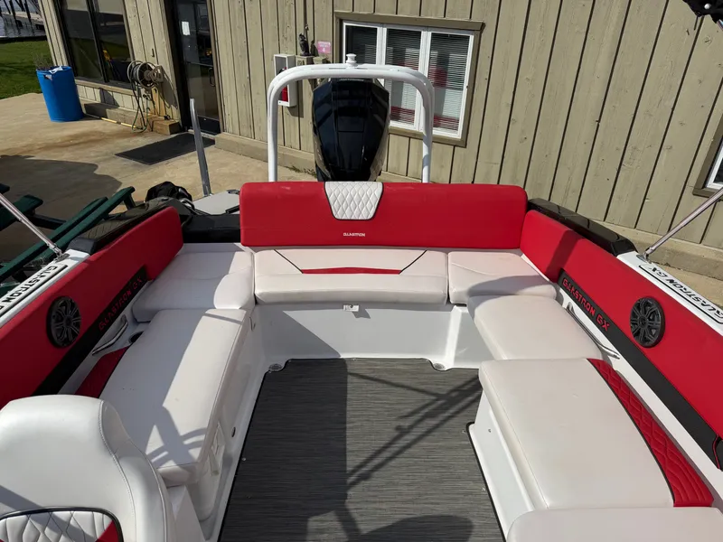 Slide: The Image of Interior of a 2022 Glastron 210 GX boat with red and white seating. - 22