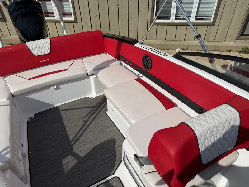 Slide: The Image of Interior of a 2022 Glastron 210 GX boat with red and white seating. - 23