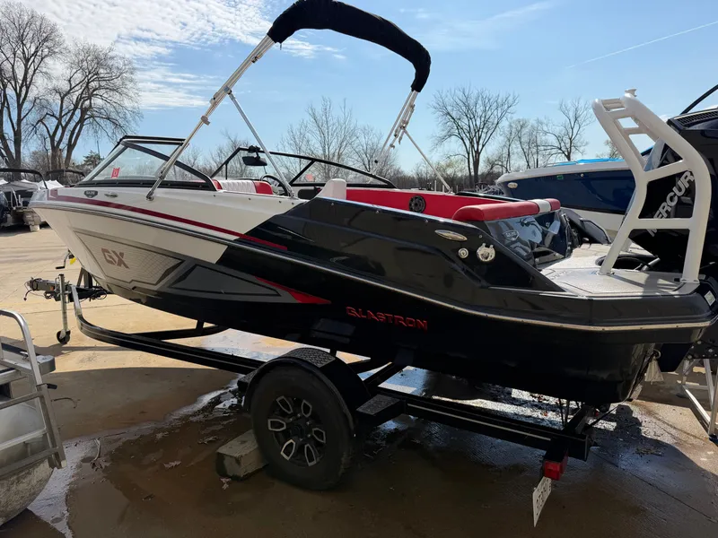 Slide: The Image of 2022 Glastron 210 GX boat on trailer outdoors. - 3