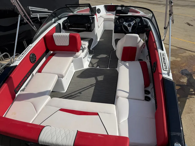 Slide: The Image of 2022 Glastron 210 GX boat interior with red and white seating. - 7